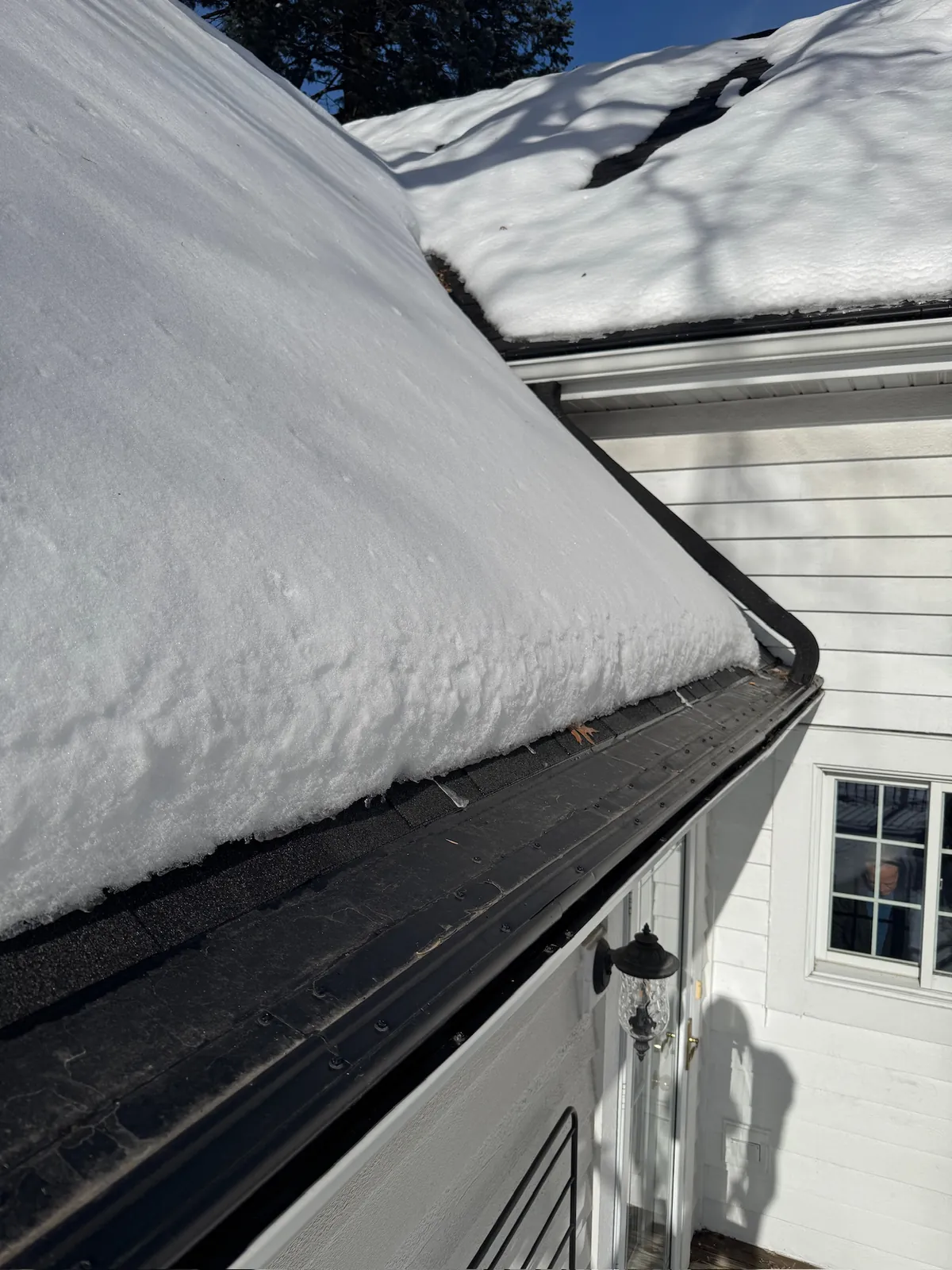 Snow held clear of a stone-coated gutter cap